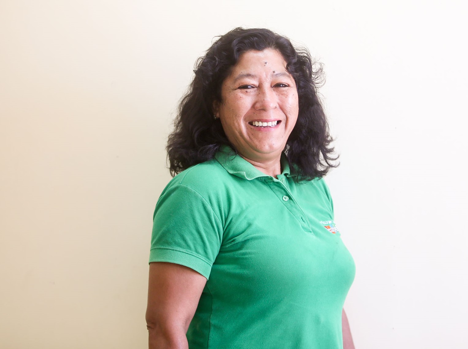 Peruvian woman in green shirt smiling