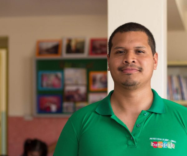Peruvian man in green shirt looking at camera
